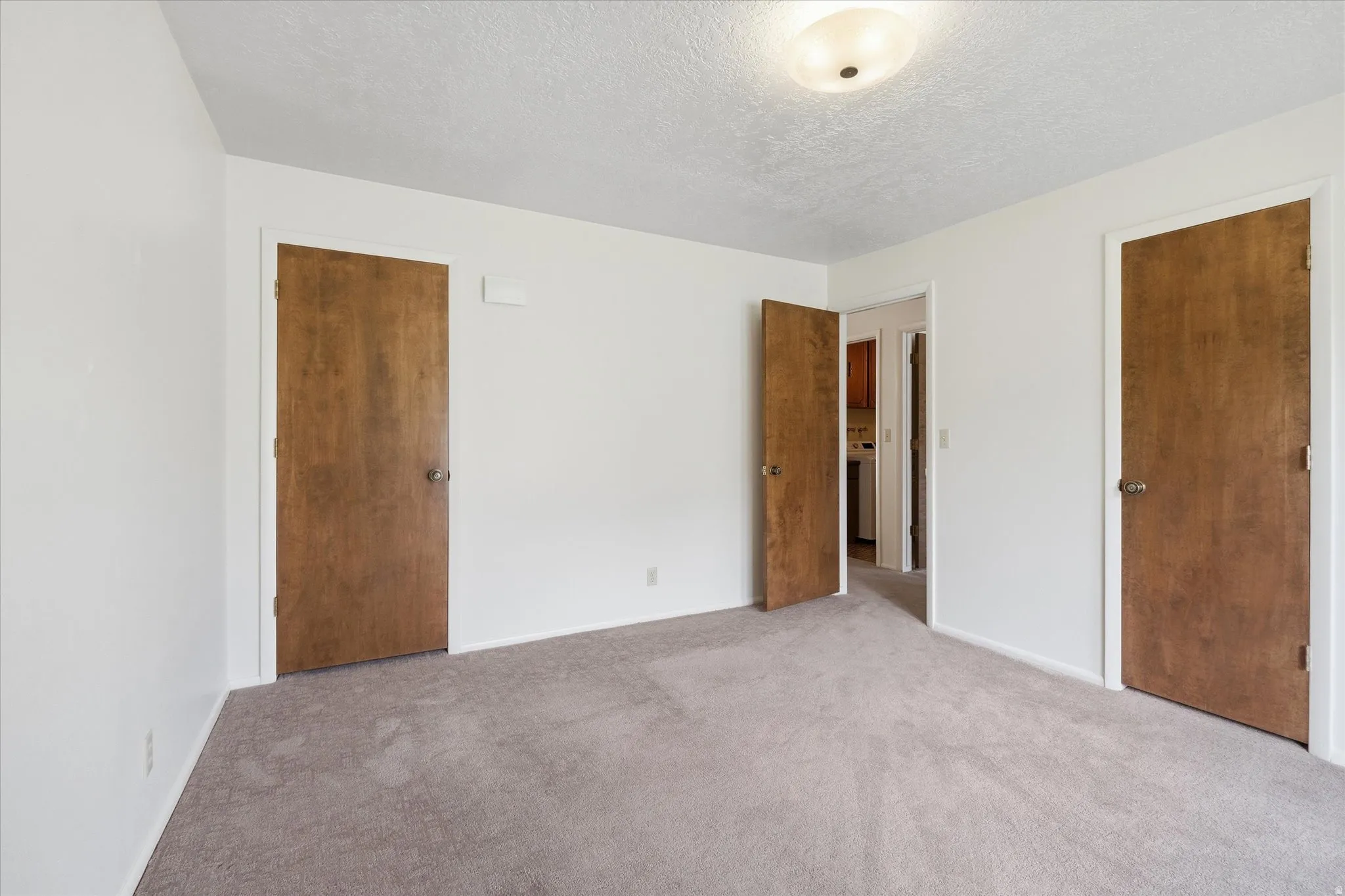 Neutral-toned carpeting throughout the room