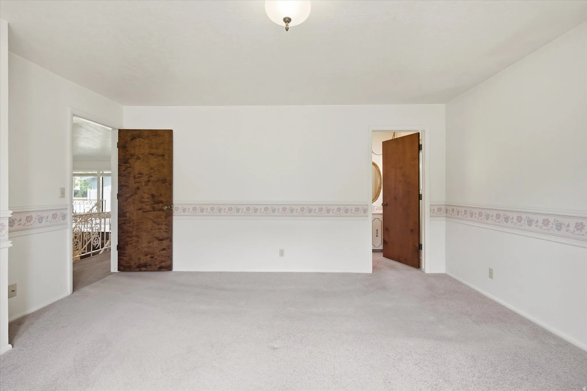 Carpeted room featuring white walls with a decorative border