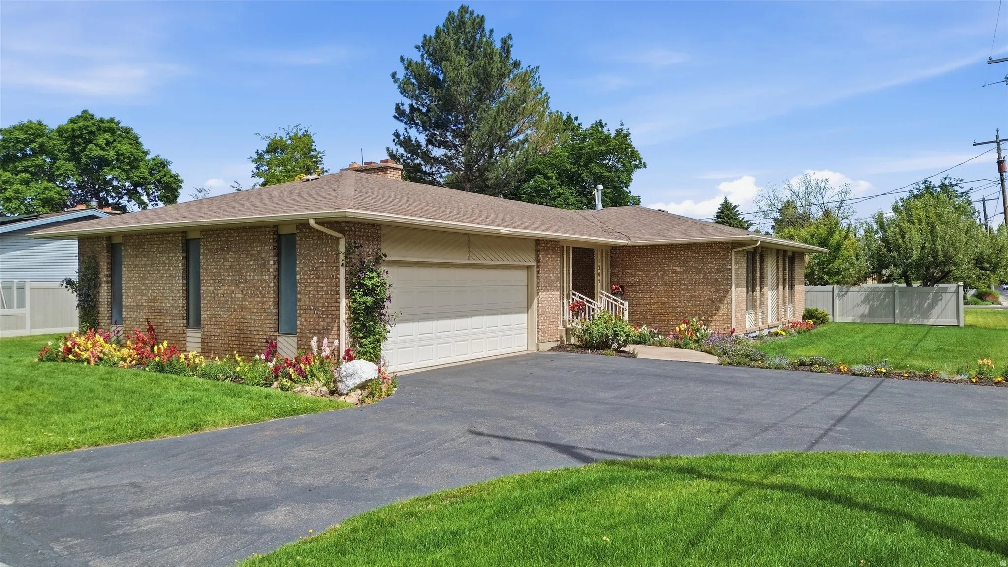 Brick exterior residence featuring an attached garage with an automatic door