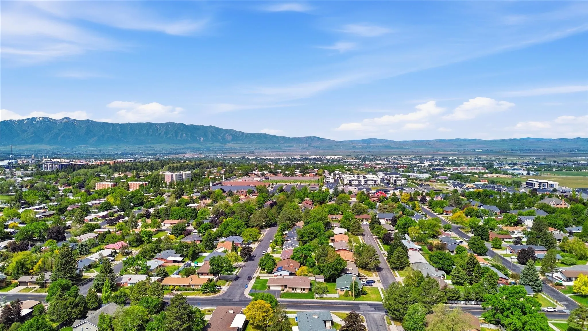 Established residential area with tree-lined streets and mountain backdrop