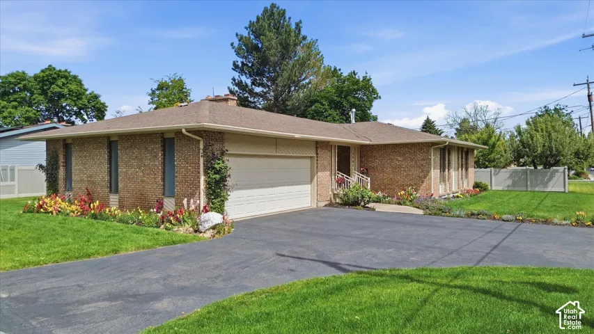 Brick exterior residence featuring an attached garage with an automatic door