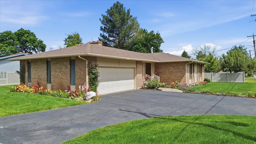 Brick exterior residence featuring an attached garage with an automatic door