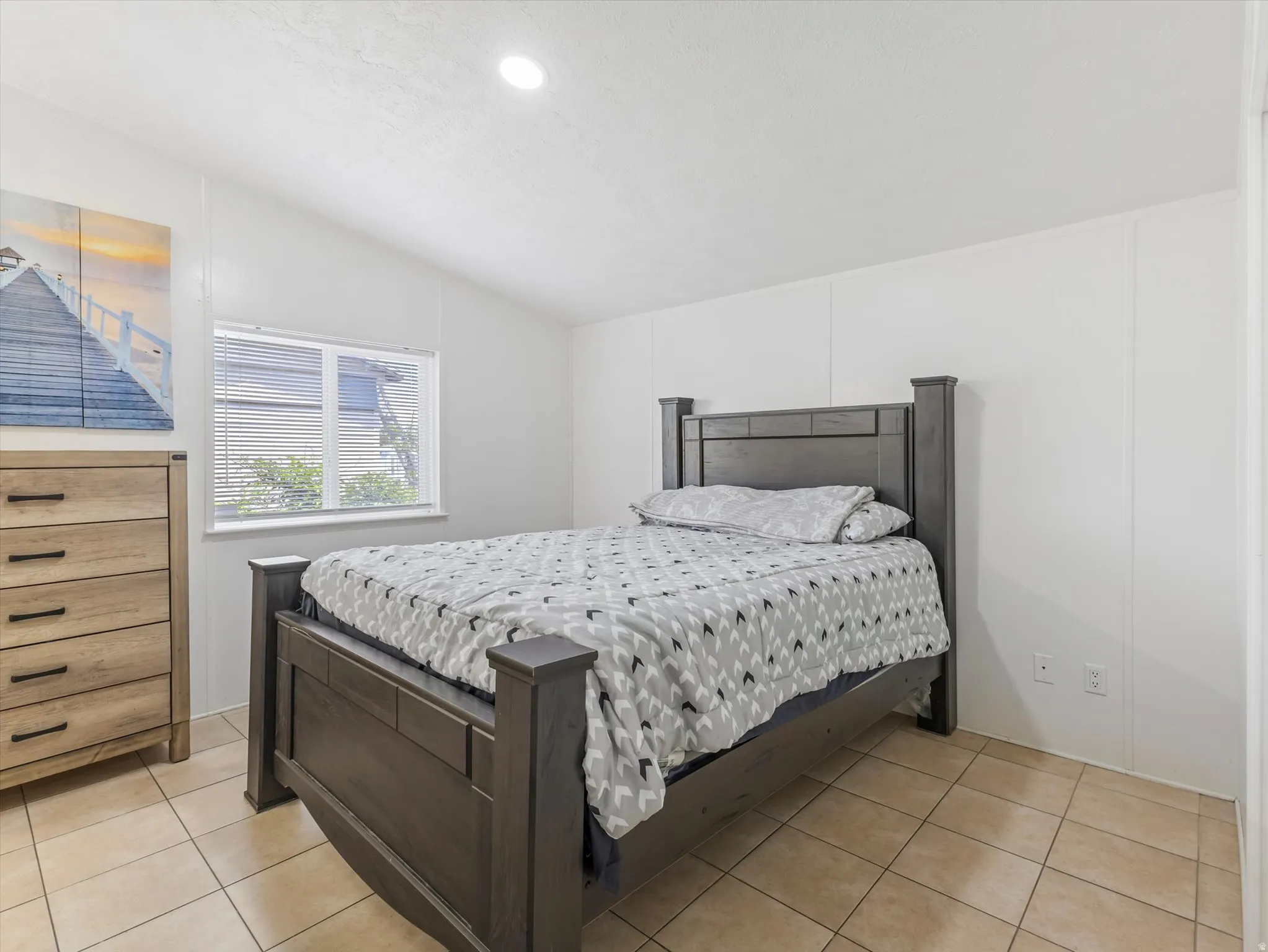 Room featuring vaulted ceilings, recessed lighting, and tile flooring