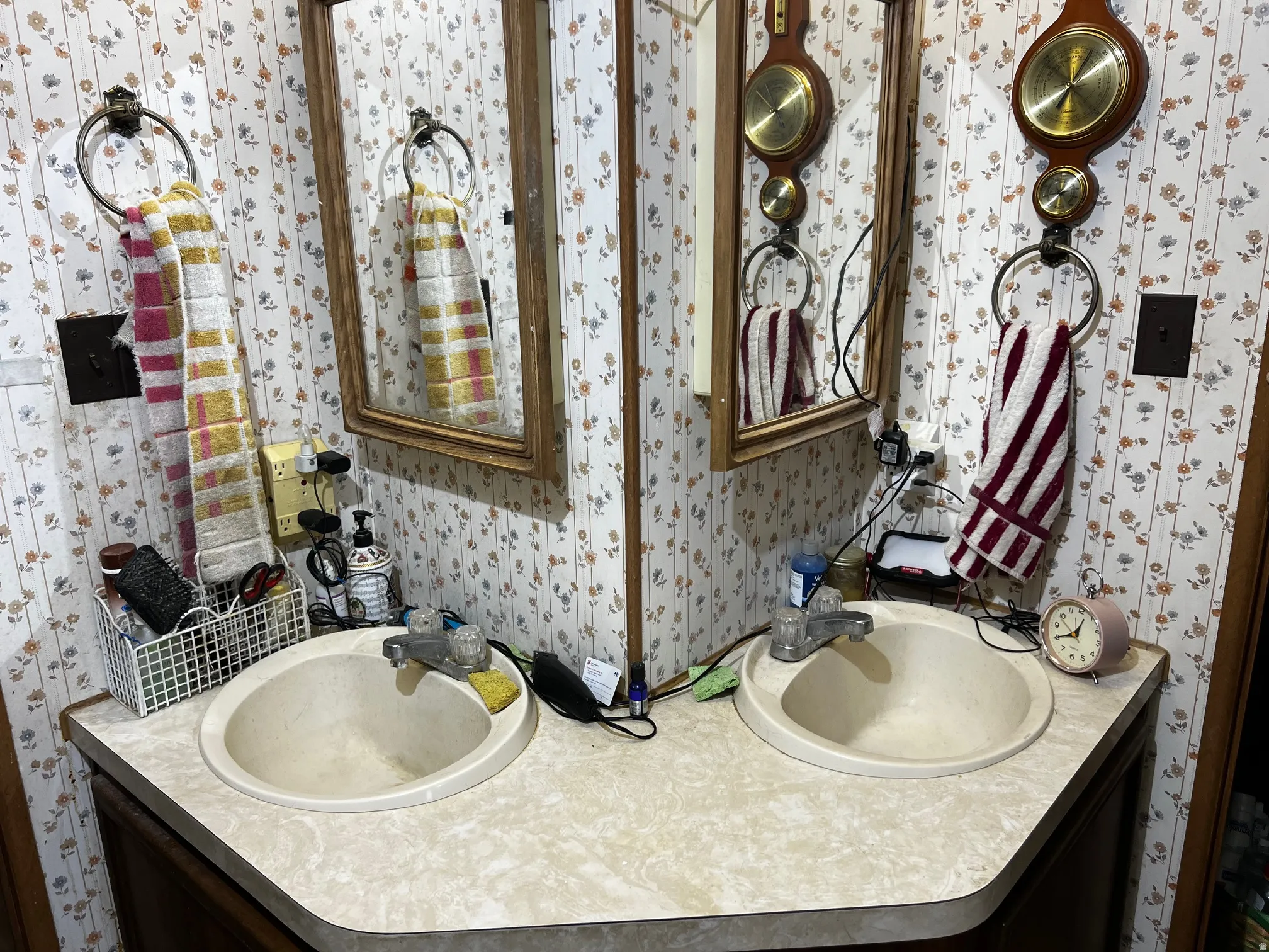 Dual vanity with integrated sinks, laminate countertop, and wood-framed mirrors