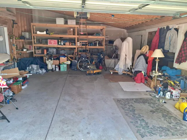 Concrete garage floor with exposed wood beam ceiling