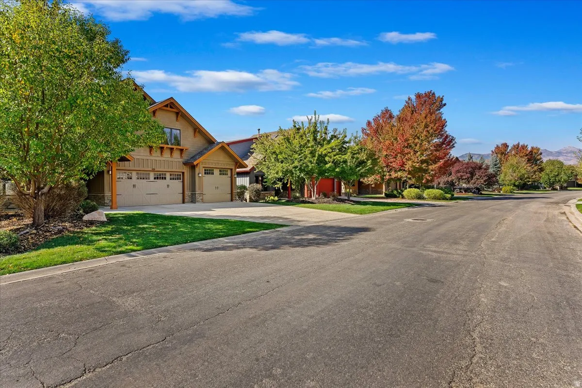Craftsman-style exterior with a stucco and wood siding facade, a two-car garage, and an additional single-car garage