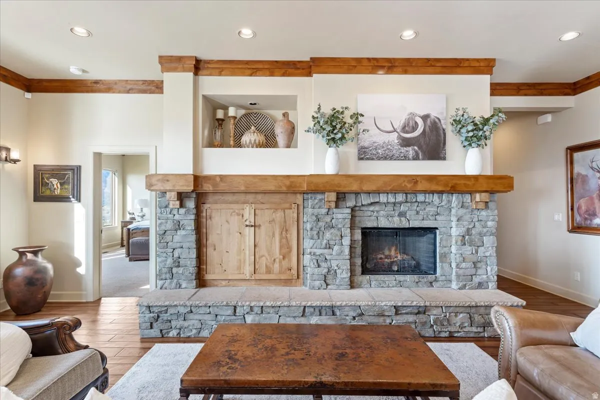 Stone-clad fireplace featuring a wood mantel and hearth
