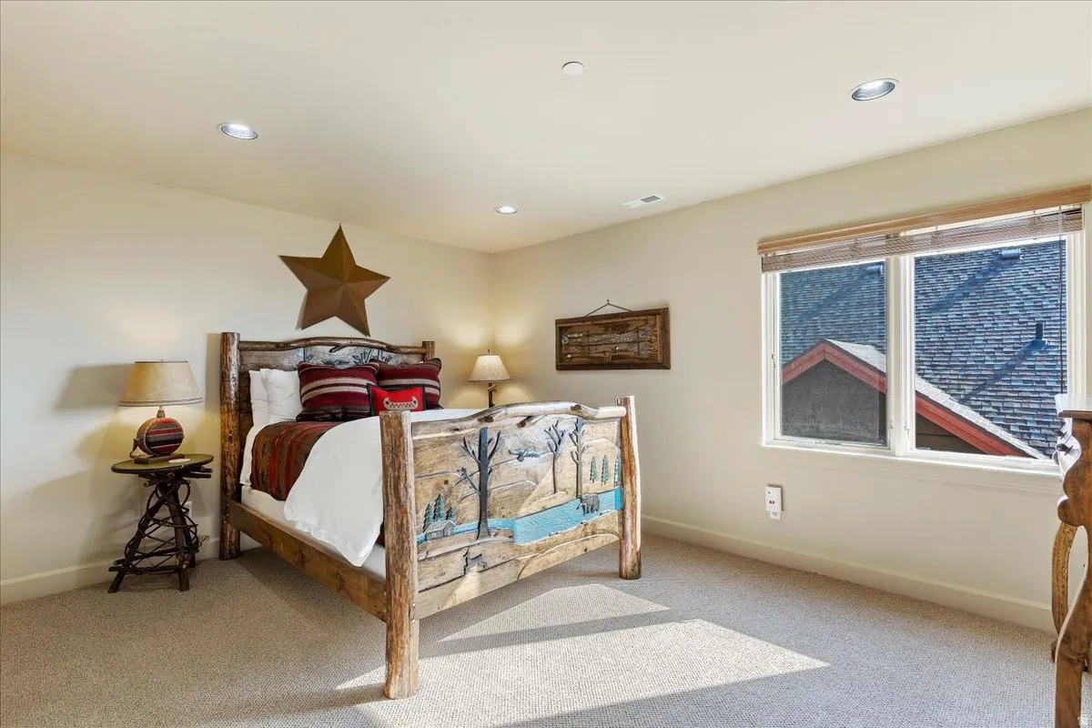 Carpeted room featuring recessed lighting and a window with wood blinds