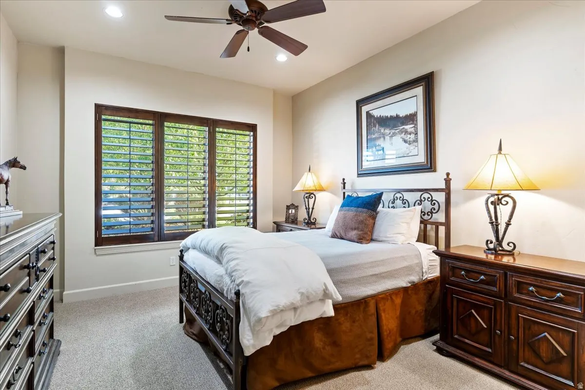 Recessed lighting illuminates neutral-toned walls and plush carpet flooring