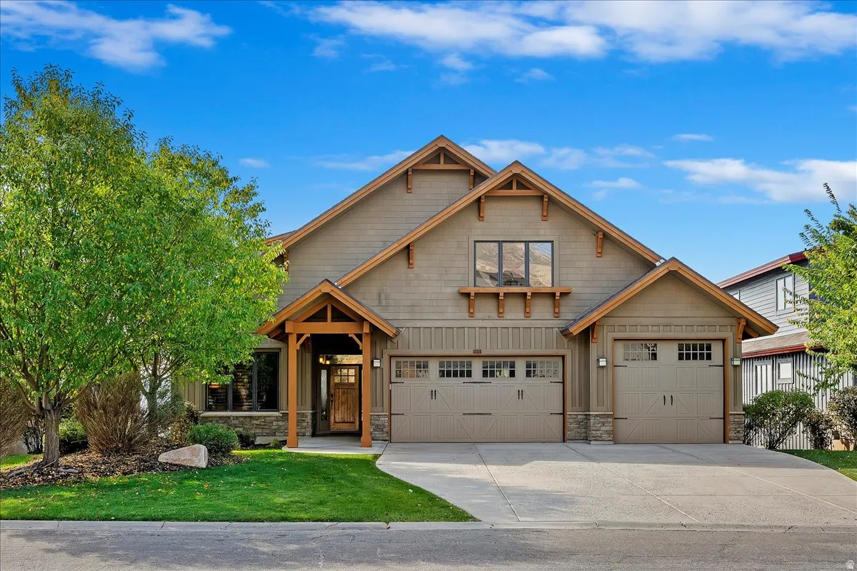 Craftsman-style exterior featuring a multi-gable roofline, board-and-batten siding, and stone accents
