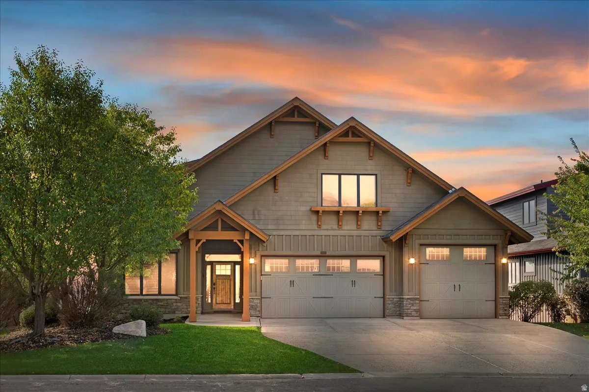 Craftsman-style exterior featuring a multi-gable roofline, board and batten siding, and stone accents
