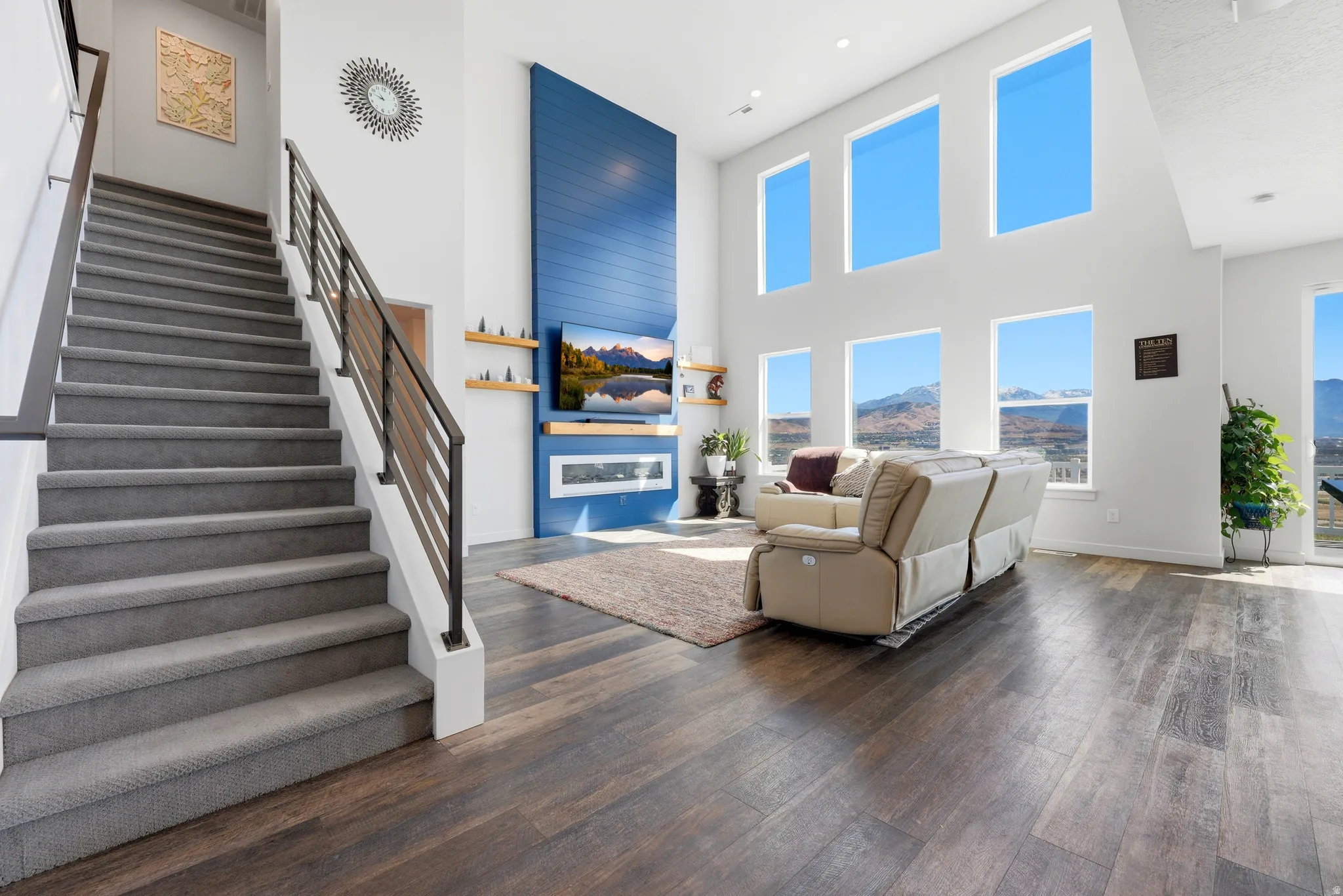 Grand staircase featuring carpeted treads and contemporary metal railings