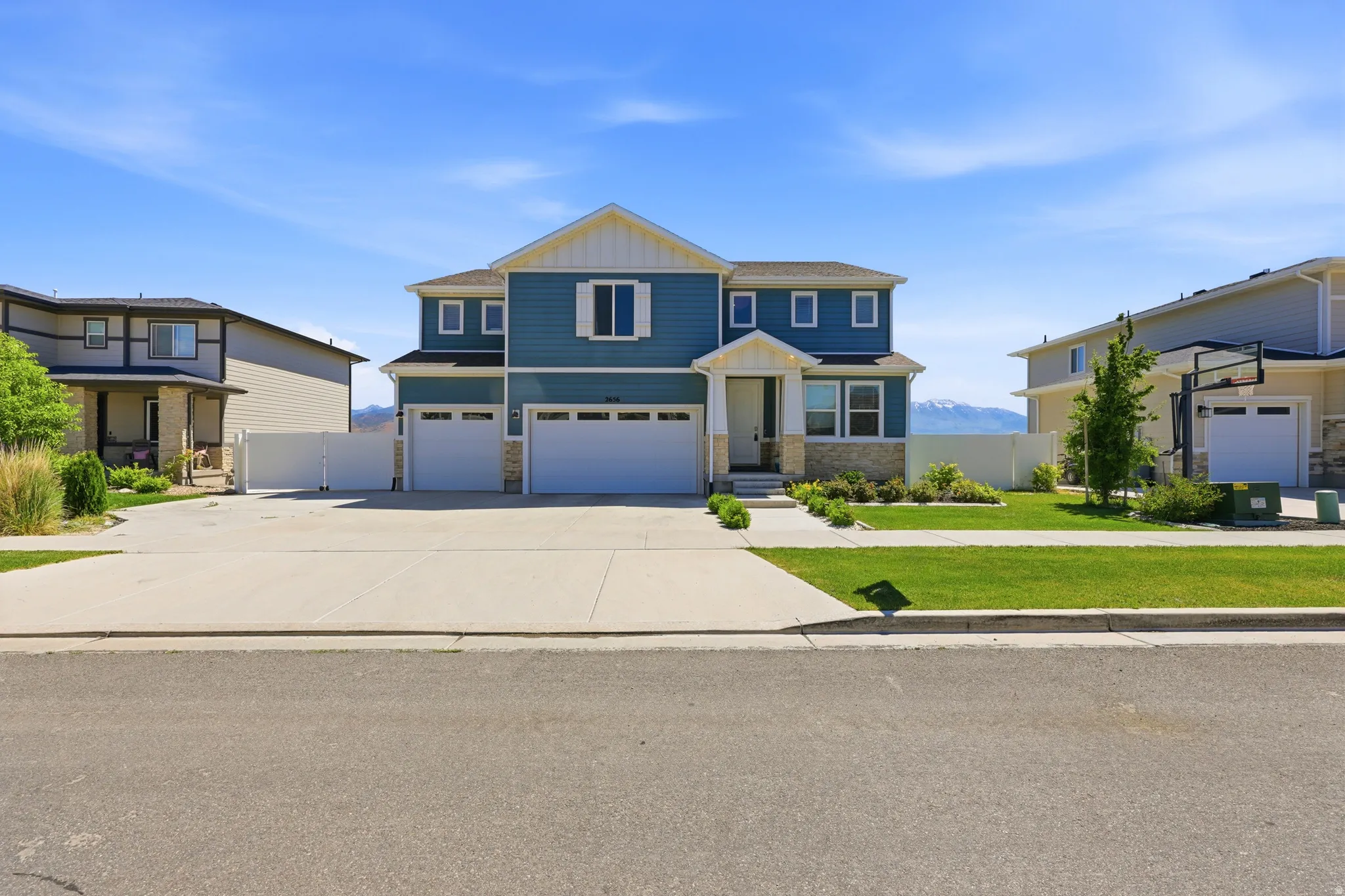 Contemporary two-story residence featuring blue siding and white trim