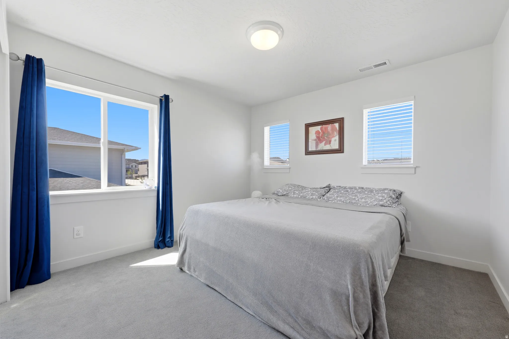 Room featuring a large picture window and two smaller windows, providing ample natural light