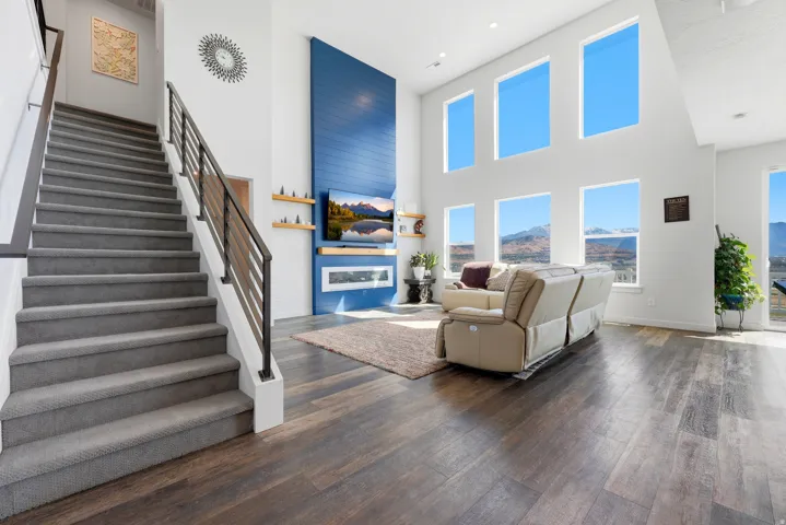 Grand staircase featuring carpeted treads and contemporary metal railings