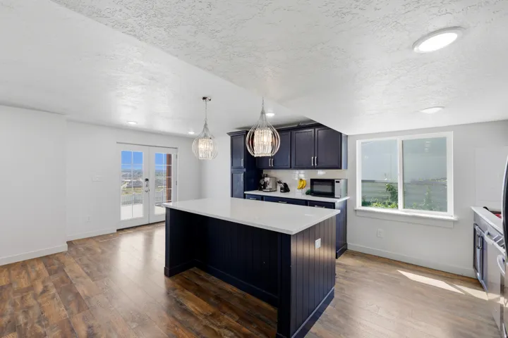 Kitchen island with a white countertop and dark blue cabinetry