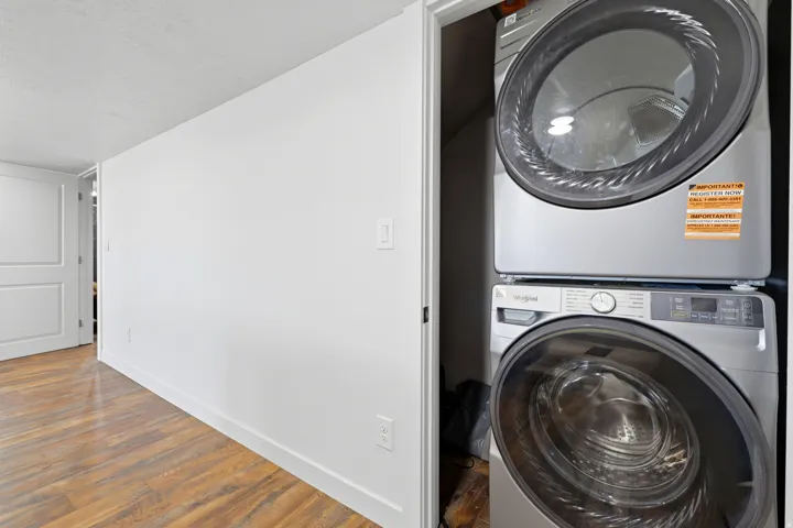 Dedicated laundry closet featuring a stacked washer and dryer unit
