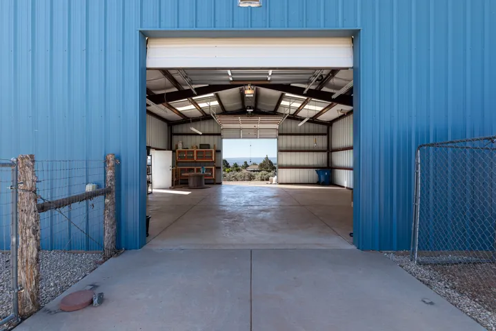 Large metal shop featuring double automatic doors.