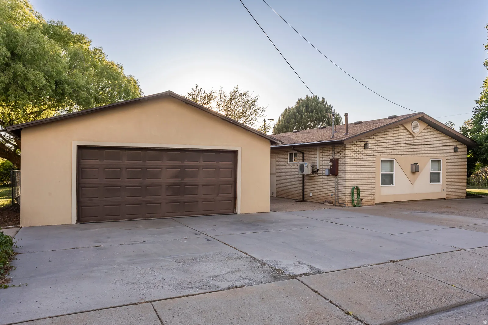 Detached two-car garage with a brown panel door