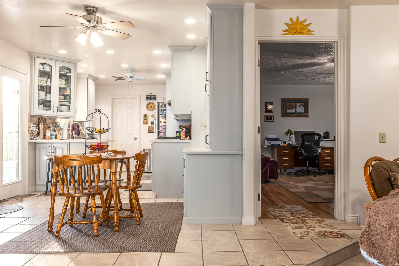 Kitchen with light-toned cabinetry, recessed lighting, and a ceiling fan