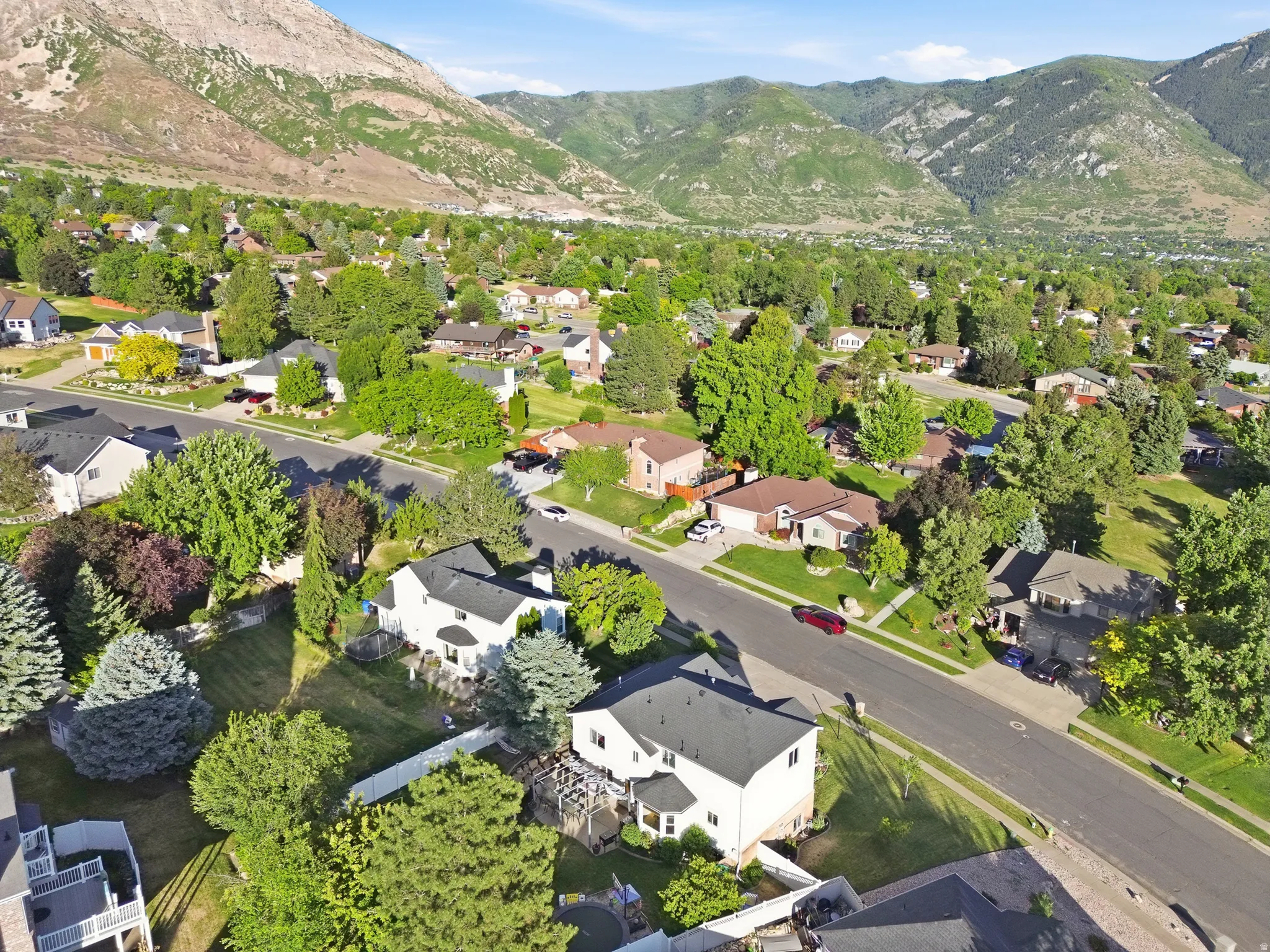 Aerial perspective showcasing a residential neighborhood with mountain backdrops