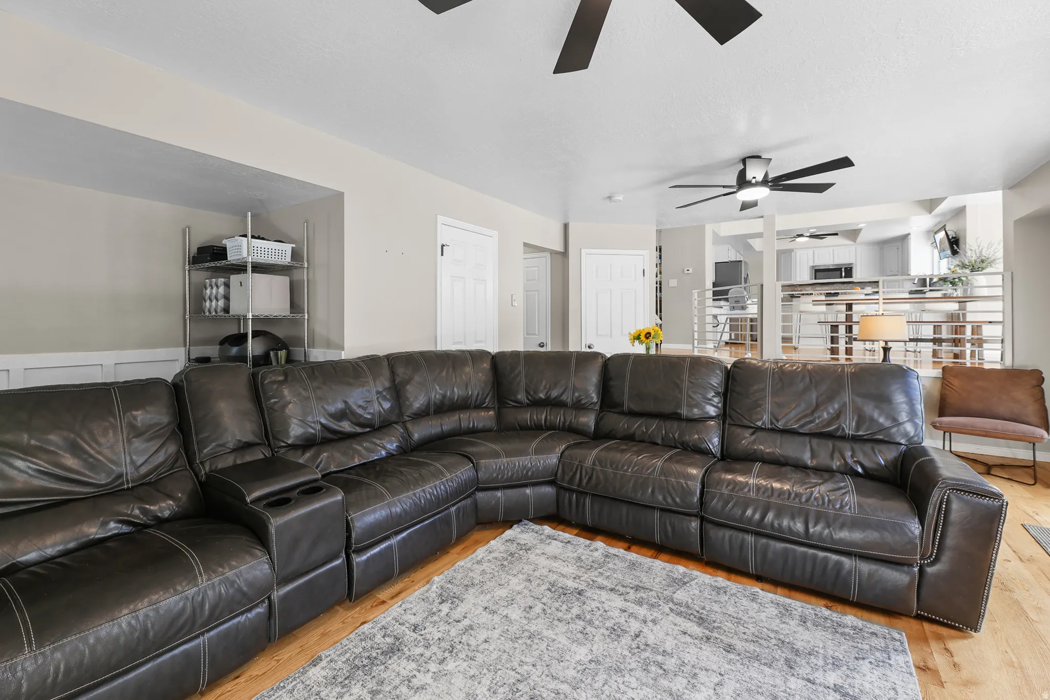 Open-concept living area featuring wood-finish flooring and a neutral color palette