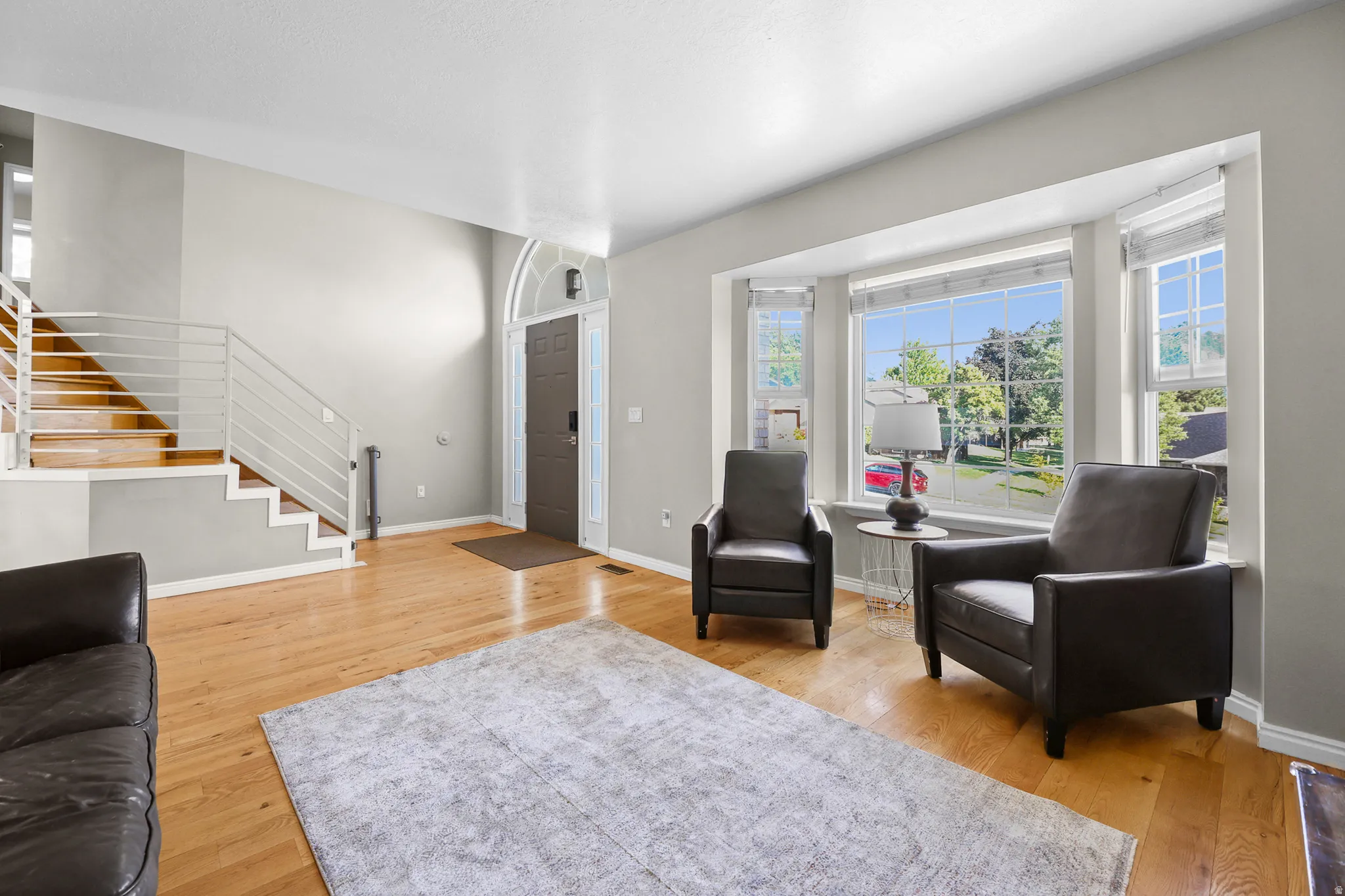 Sunlit living area with wood-finish flooring
