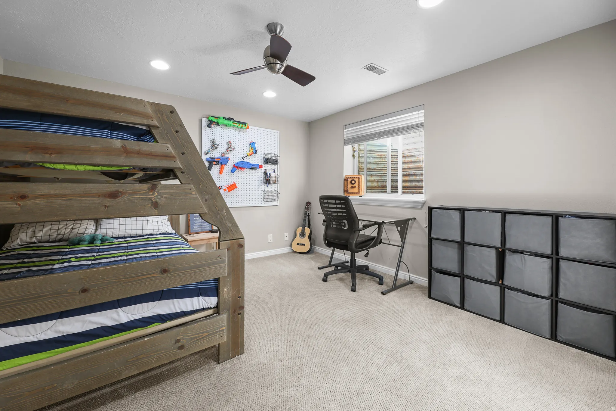 Spacious room featuring neutral carpeting, recessed lighting, and a ceiling fan