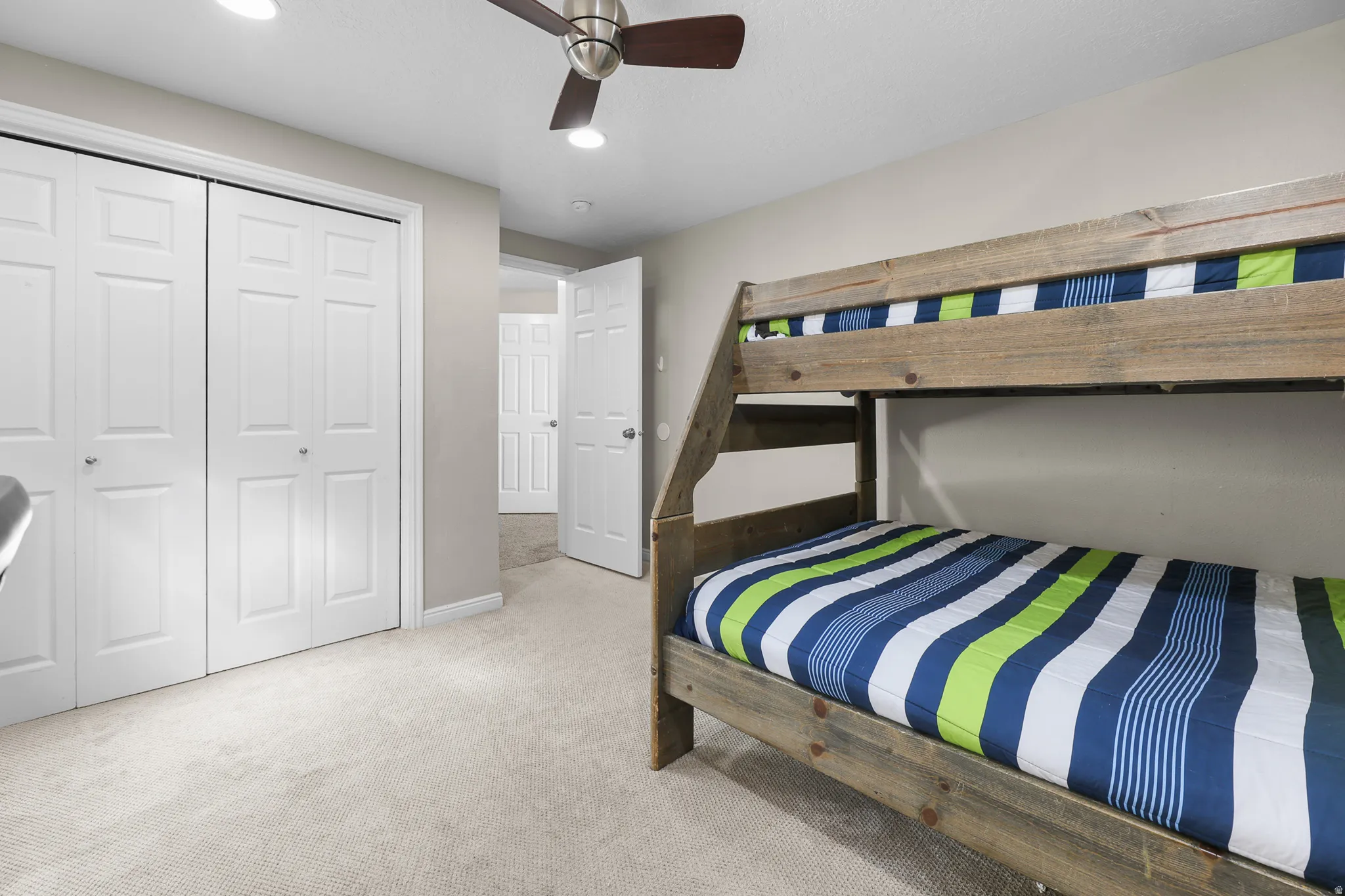 Bedroom featuring a flush-mount ceiling fan, recessed lighting, and soft carpet flooring