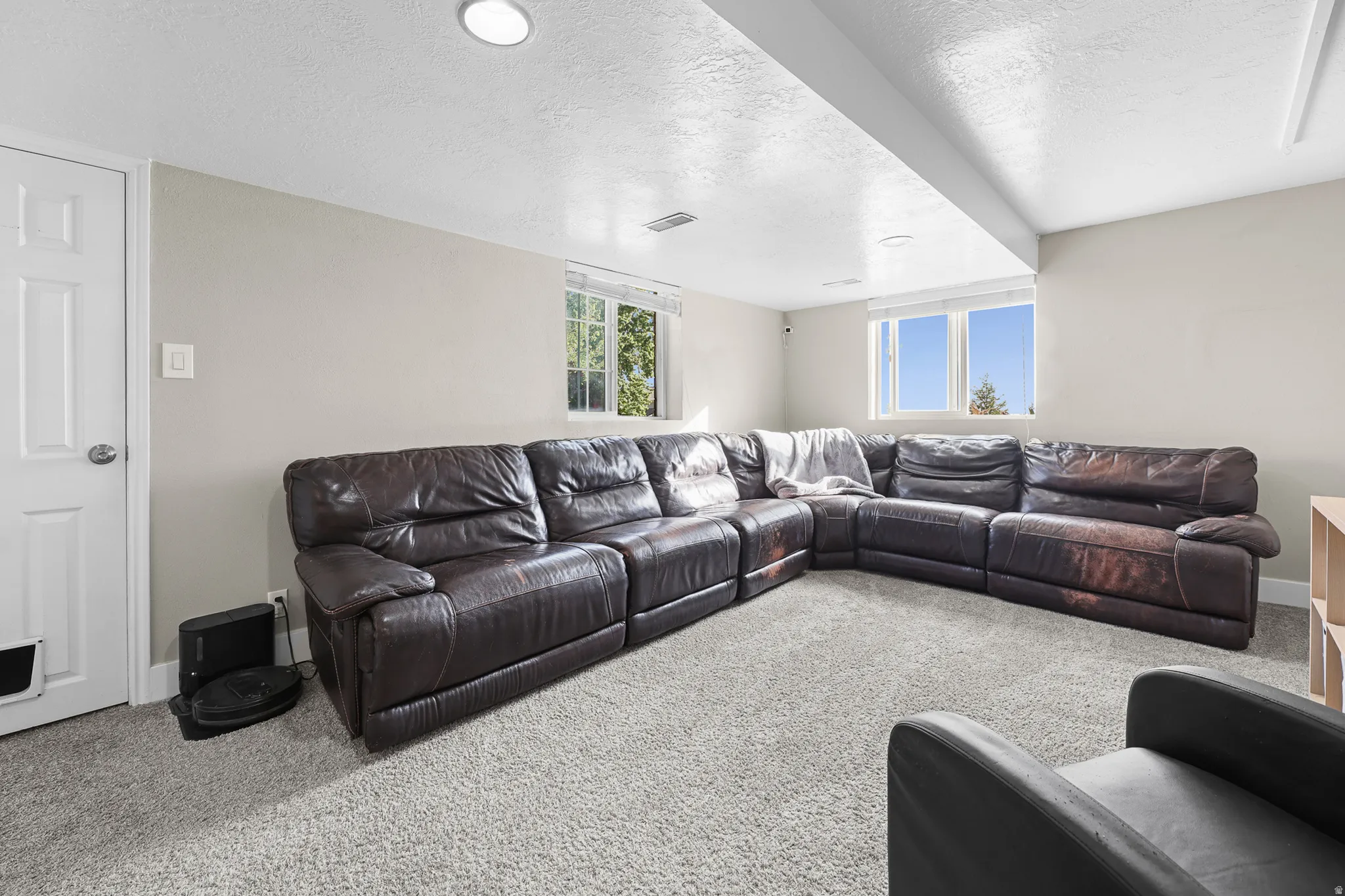 Carpeted room featuring recessed lighting and windows providing natural light