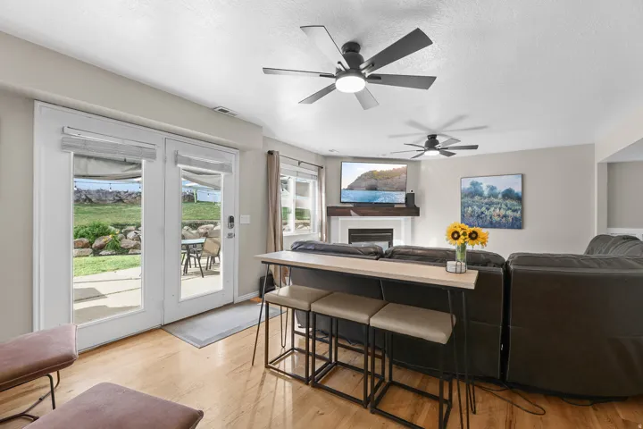 Living area featuring light wood-finish flooring, recessed lighting, and dual ceiling fans