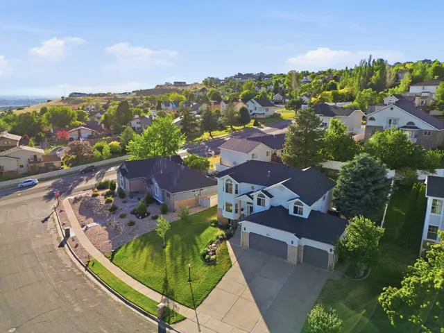 Two-story residence with a three-car garage and a paved driveway