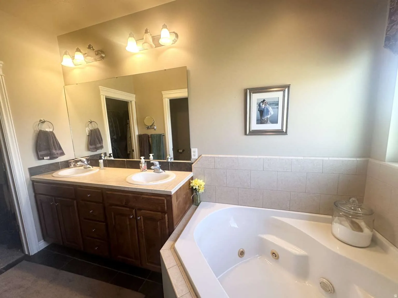 Double vanity with dark wood-finish cabinetry and dual undermount sinks