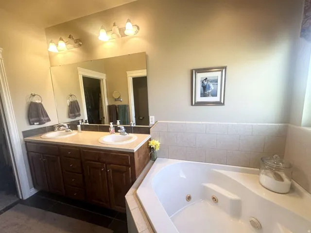 Double vanity with dark wood-finish cabinetry and dual undermount sinks