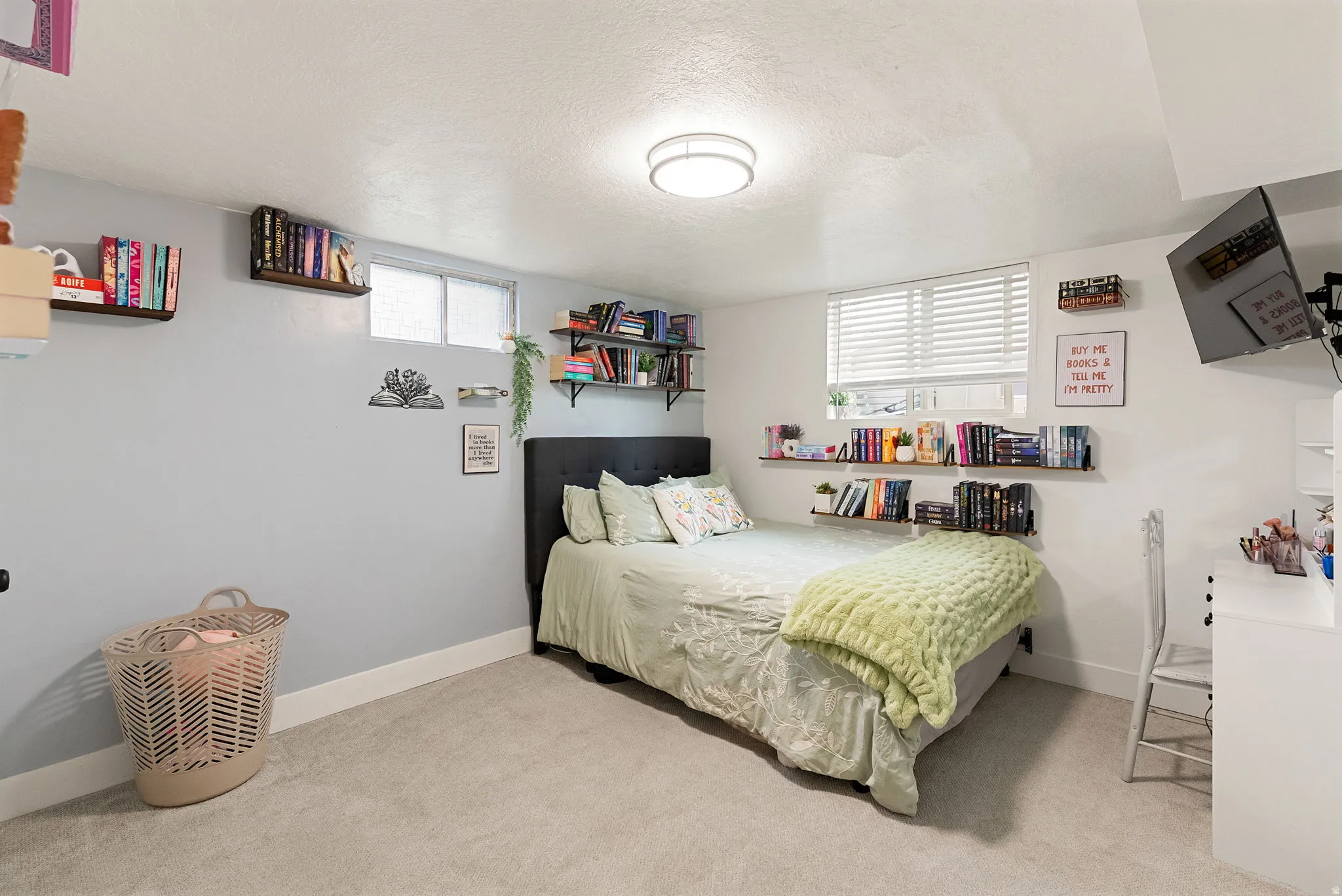 Carpeted bedroom featuring a window with blinds, recessed lighting, and wall-mounted shelving
