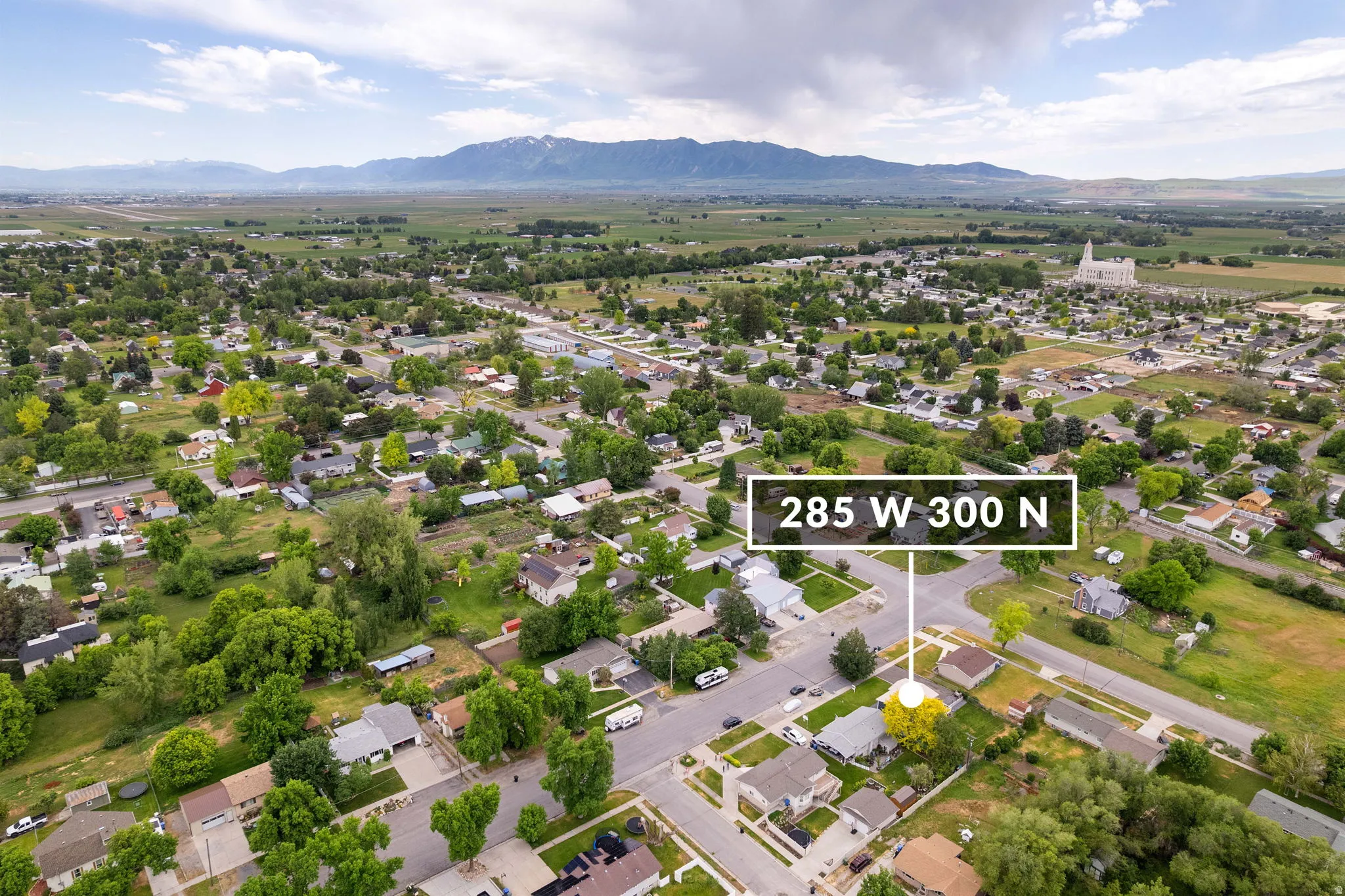 Aerial perspective showcasing a residential area with varied housing styles and mature trees