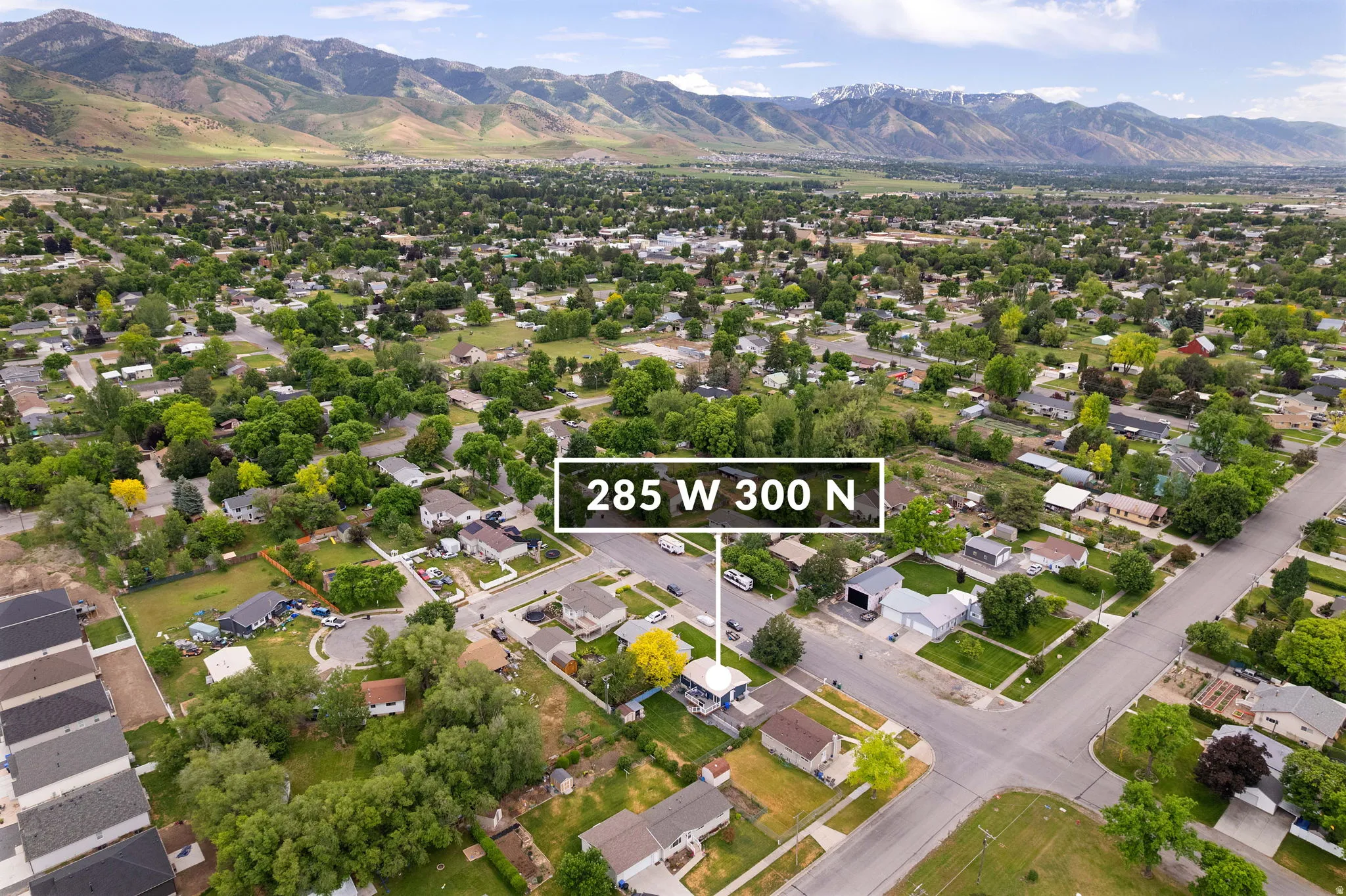 Aerial perspective of a residential neighborhood with a distant mountain range backdrop