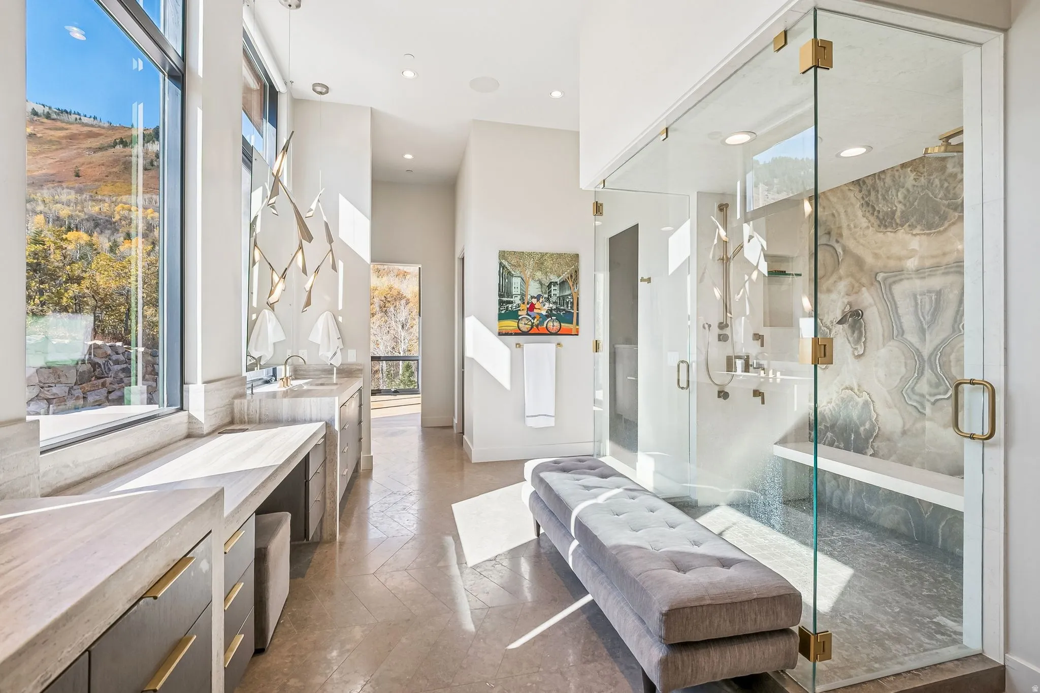 Bathroom with stone tile flooring, vanity, a marble finish shower, recessed lighting, and a high ceiling
