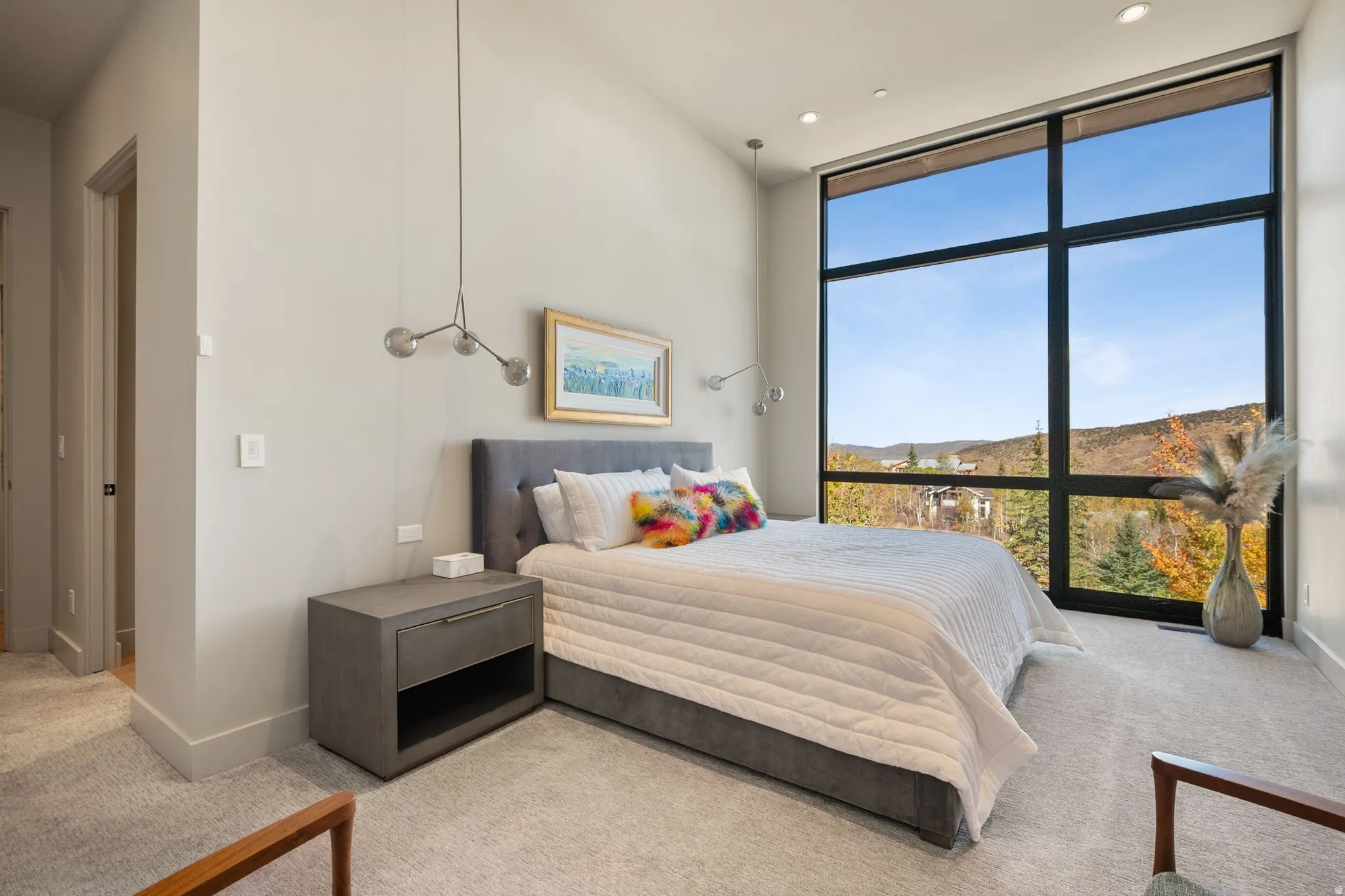 Bedroom with expansive windows, light colored carpet, recessed lighting, and a mountain view