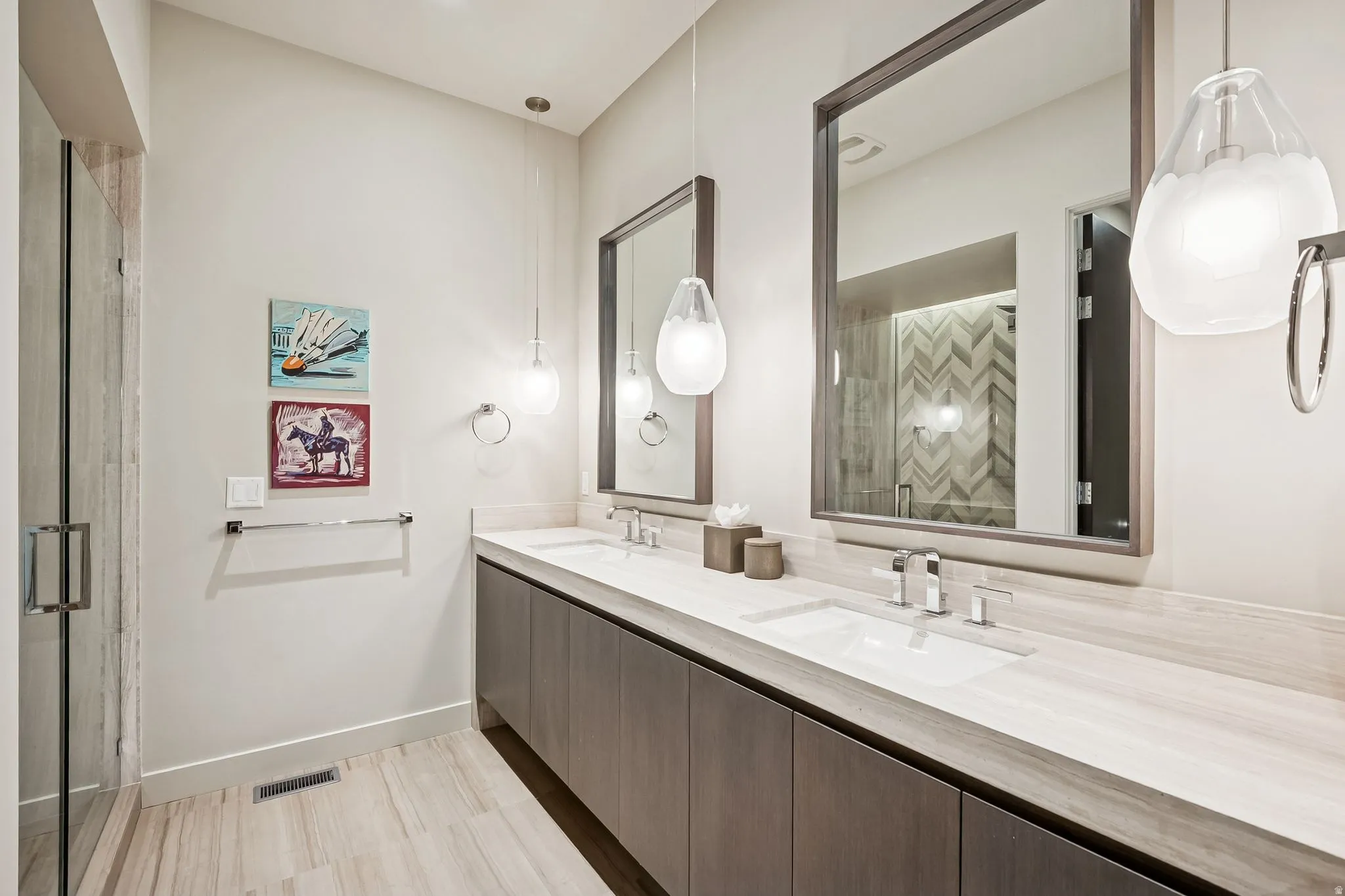 Full bathroom featuring double vanity and a stall shower
