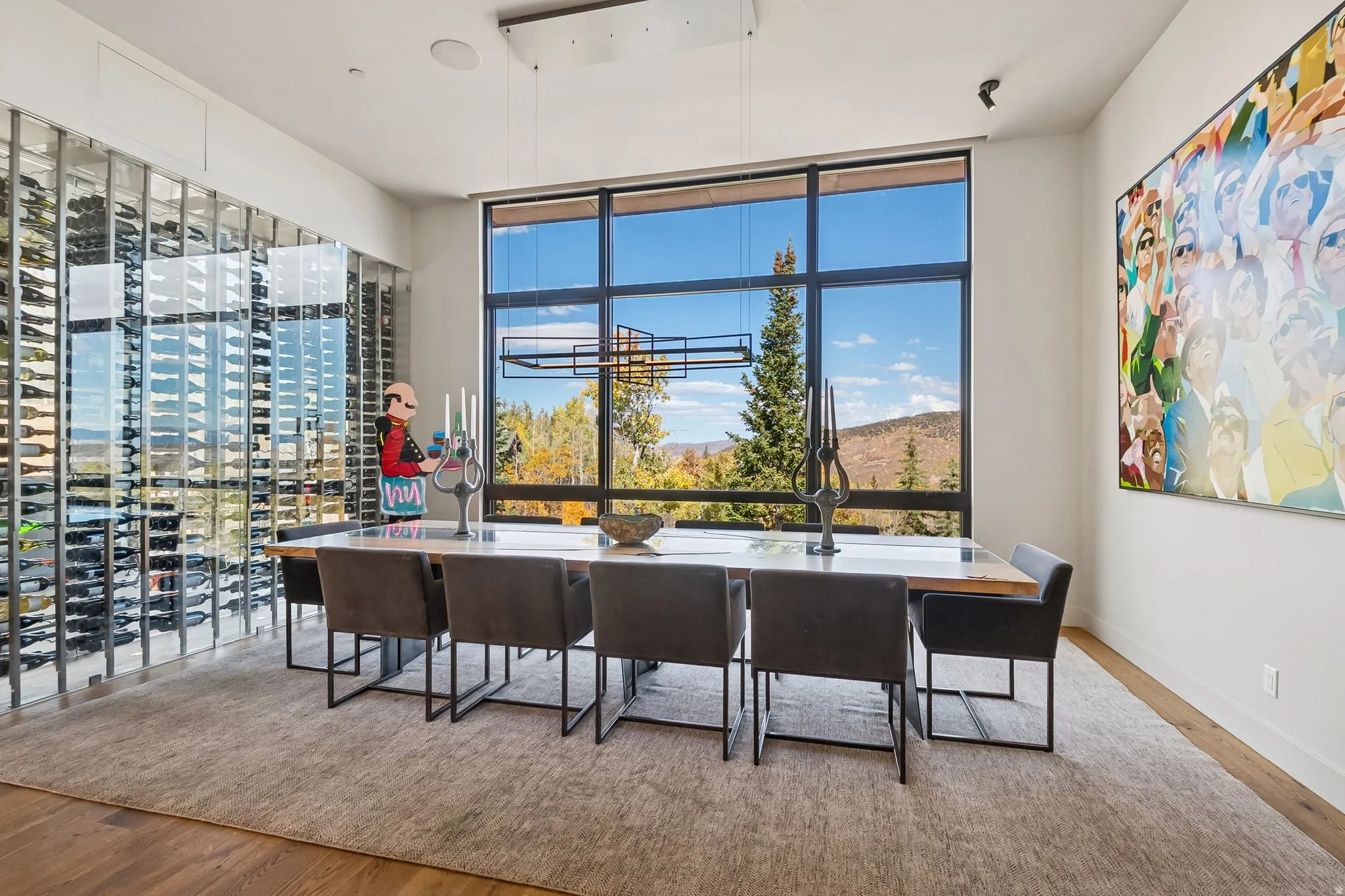 Dining room with wood finished floors, healthy amount of natural light, and expansive windows