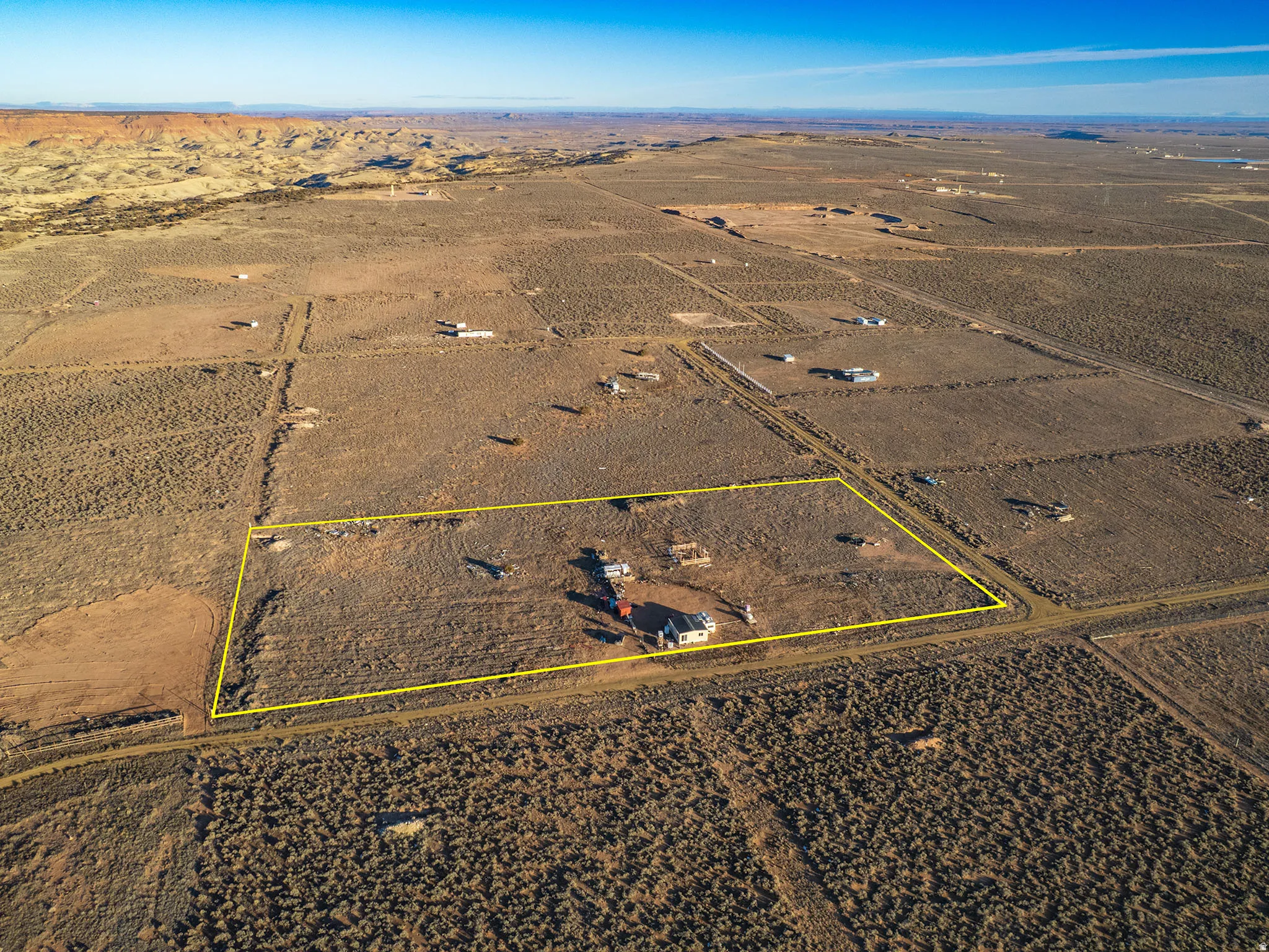 Expansive desert property featuring a distinct rectangular parcel, defined by a yellow boundary