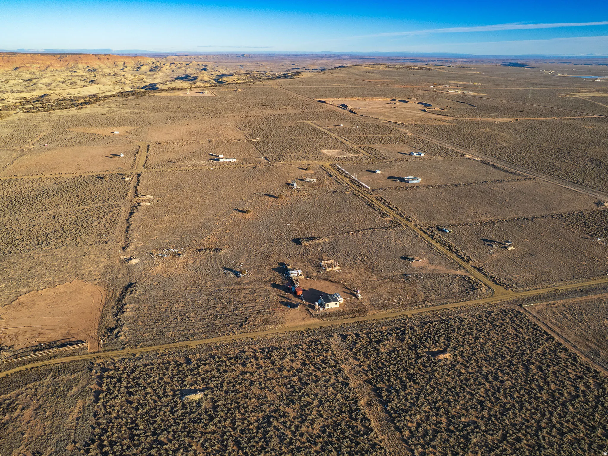 Expansive desert landscape featuring a diverse topography and distant rock formations