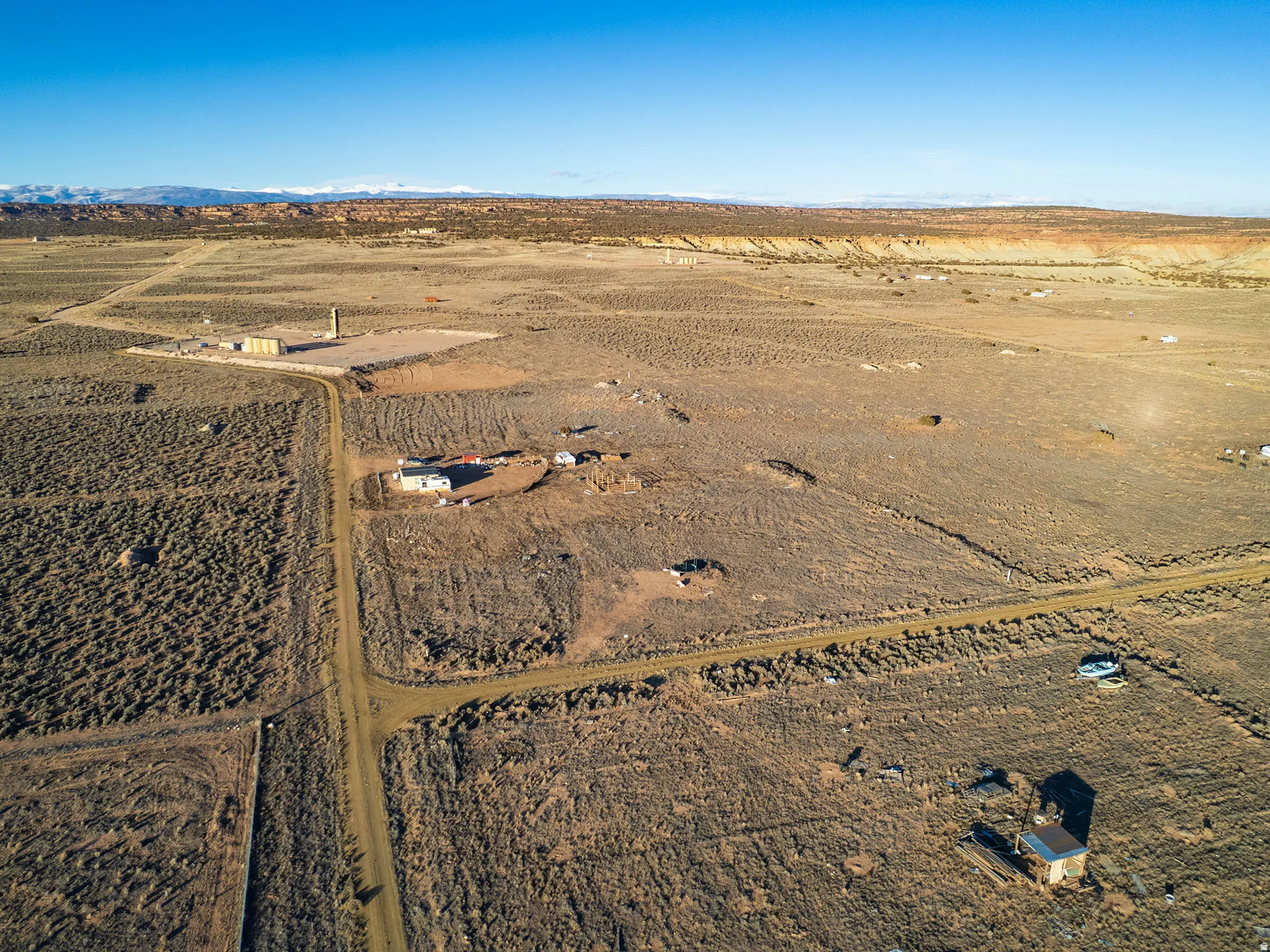 Expansive land parcel featuring multiple structures, including a primary residence and outbuildings