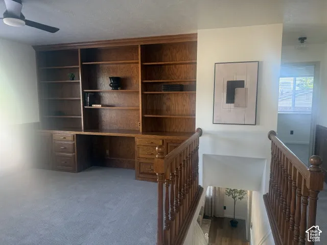 Expansive built-in shelving unit with integrated desk space and drawer storage