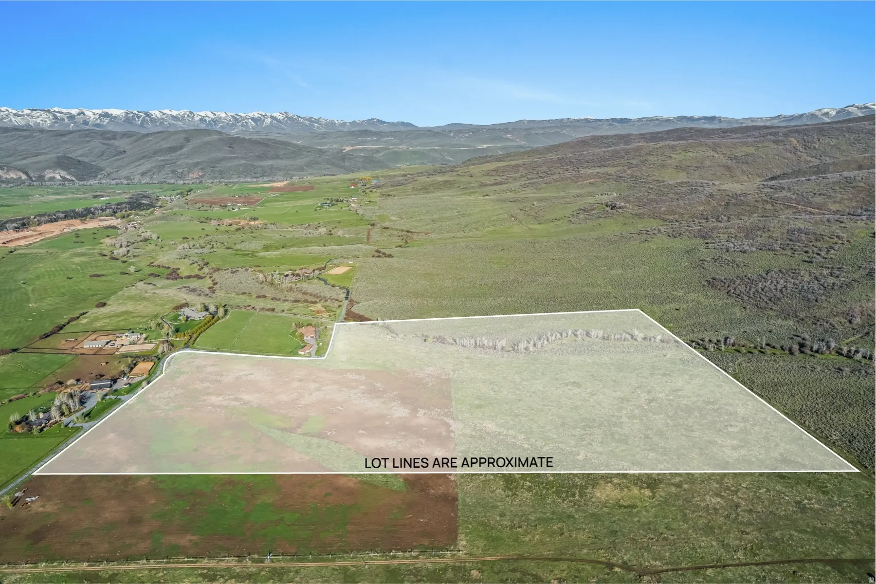 Expansive raw land parcel featuring varied terrain, including flat and sloped areas