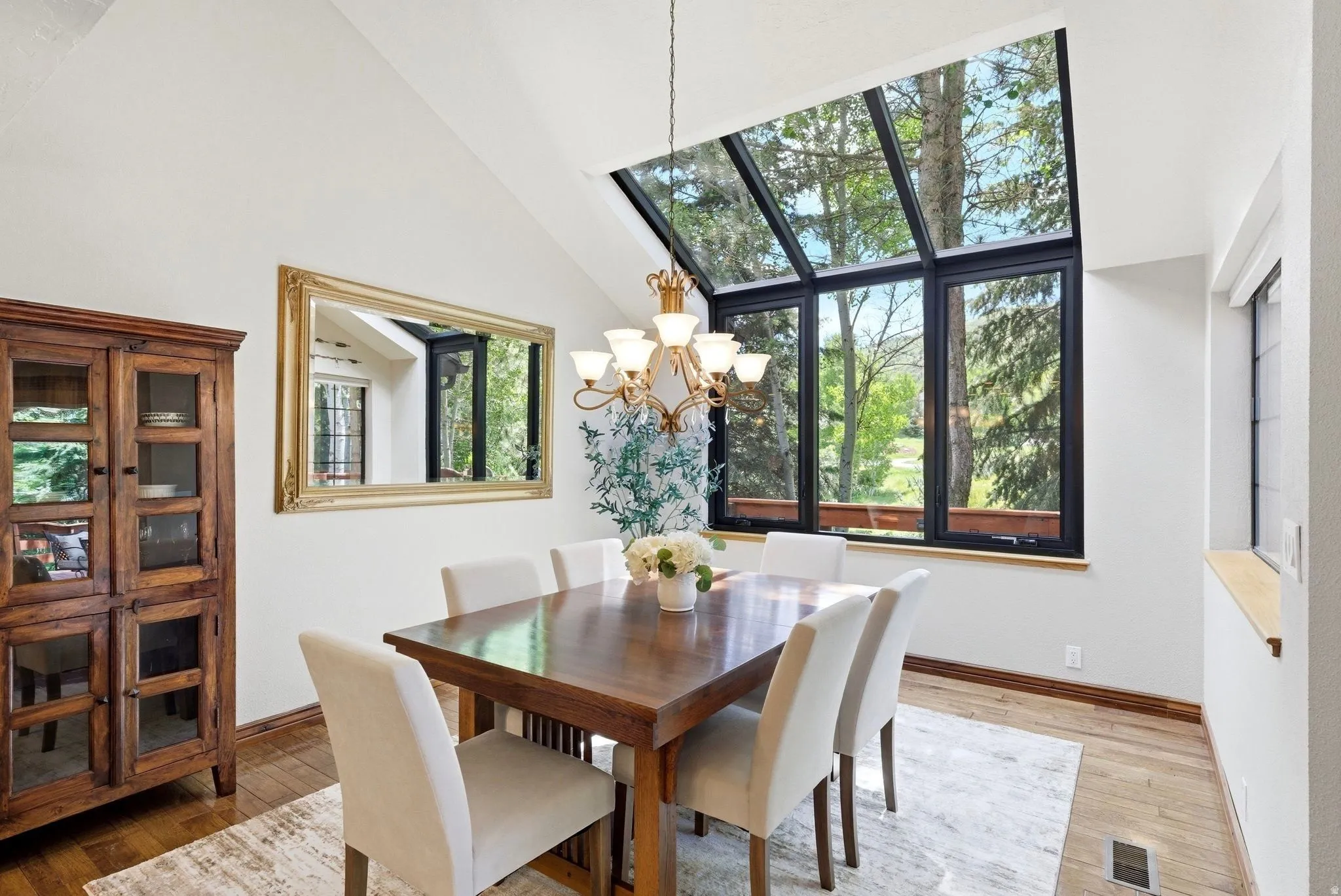 Vaulted ceilings enhancing the dining area with a prominent multi-pane window assembly