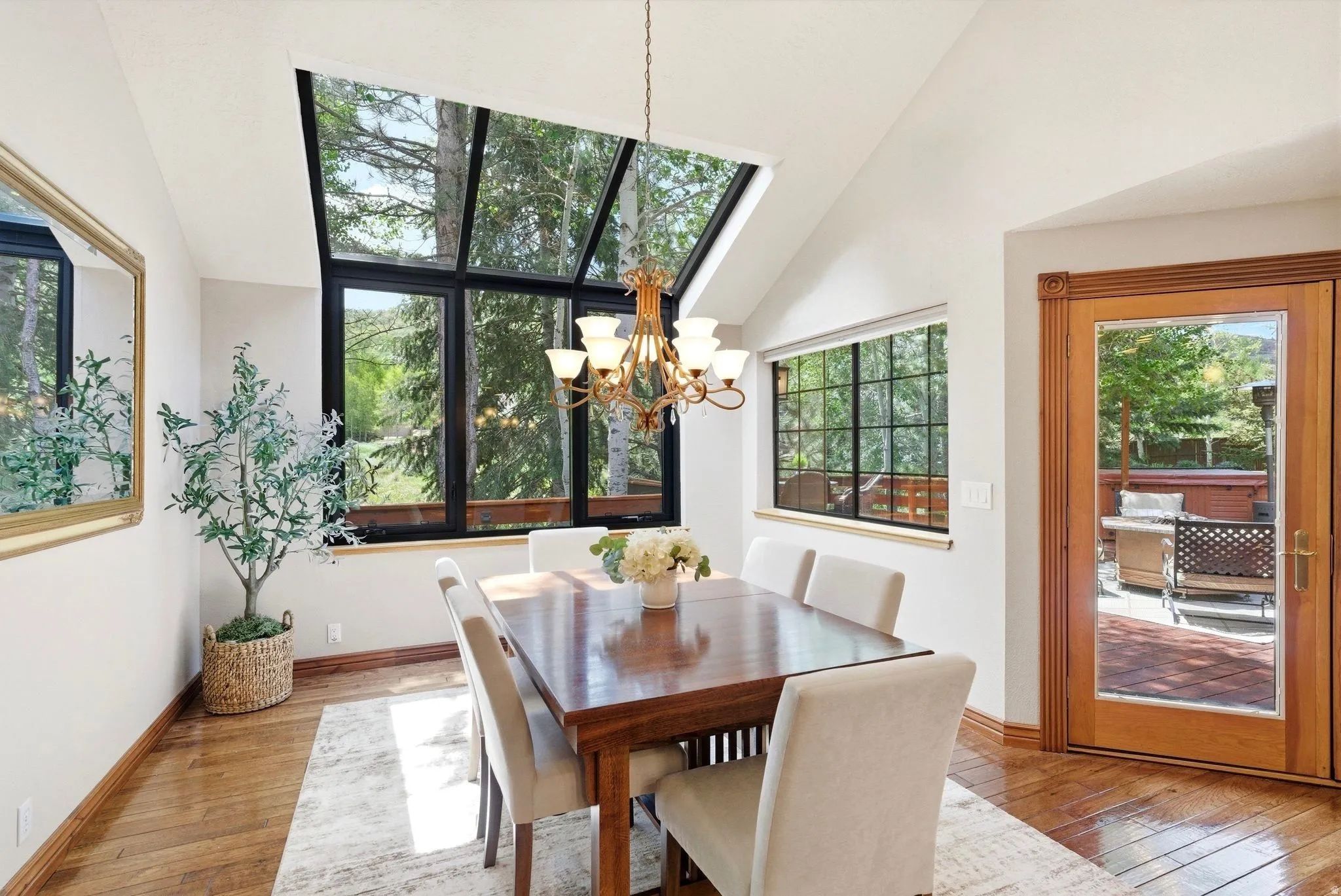Dining area with a striking vaulted ceiling and extensive glass paneling