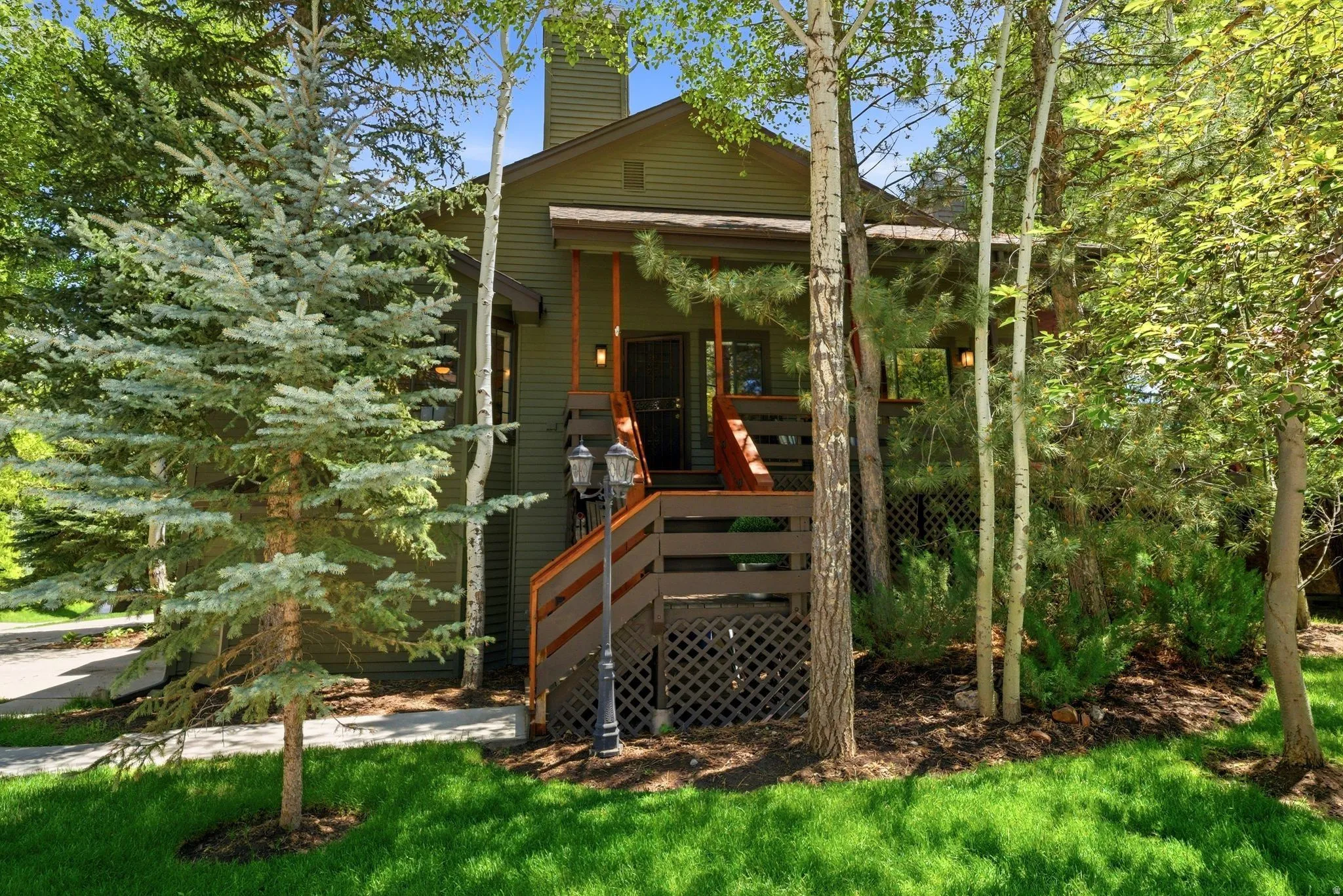 Exterior featuring a prominent wooden staircase, a covered porch, and horizontal siding
