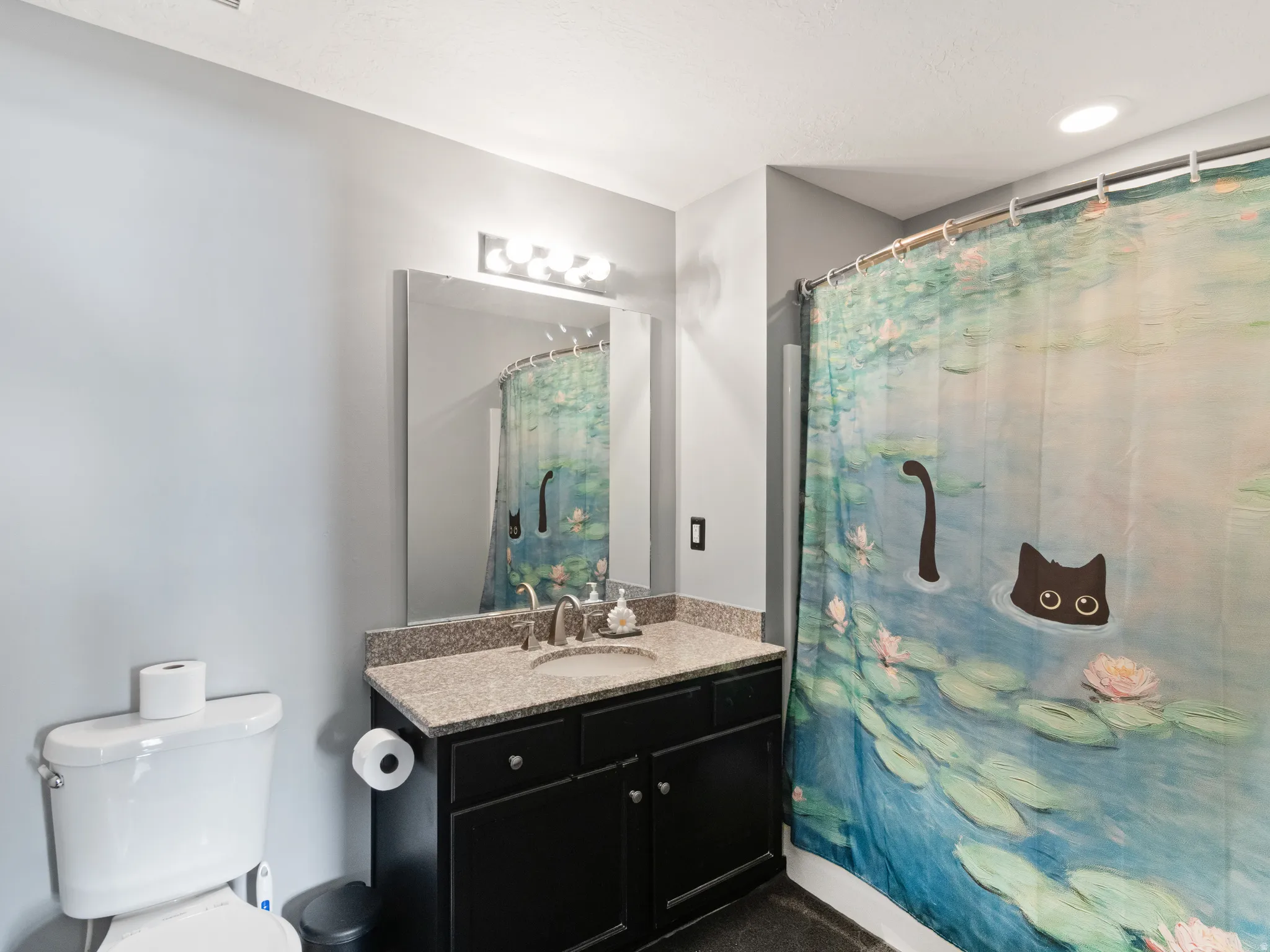Bathroom vanity with a dark wood-finish cabinet and a light-colored countertop